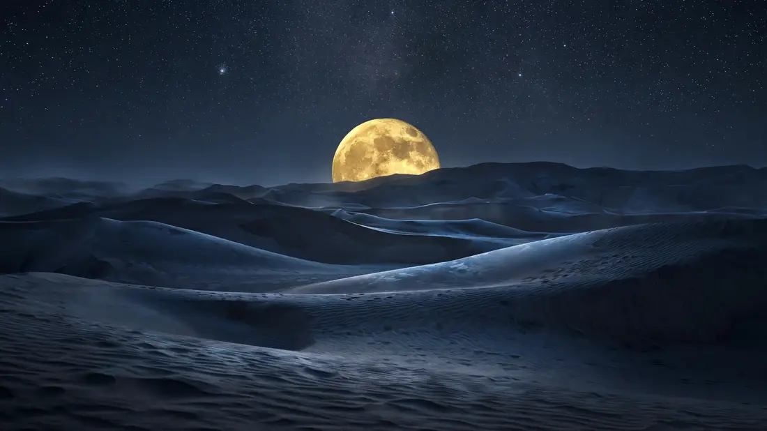 An unusually large full moon rising over desert dunes at night