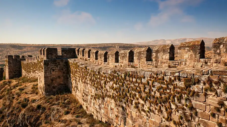 Stone fortress walls of an Anatolian citadel under a wide sky