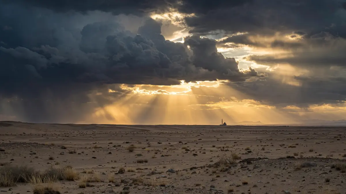 Golden light breaking through clouds over a desert mosque